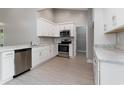 Modern kitchen featuring white cabinets, marble countertops, and stainless steel appliances at 375 Log Cabin Rd., Loris, SC 29569