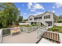 Spacious waterfront deck offers a relaxing space, complete with a cushioned bench and scenic views at 615 N 17Th Ave. N, Surfside Beach, SC 29575