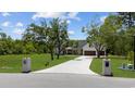 Curved driveway, white farmhouse with landscaping, and brick mailbox at 2192 Eastwoods Dr., Conway, SC 29526