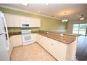 Kitchen with granite countertops, white cabinets, and a breakfast bar at 110 South Shore Blvd. # 202, Longs, SC 29568