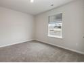 Cozy bedroom features carpet flooring, a window, and light neutral walls at 3870 Lady Bug Dr., Shallotte, NC 28470