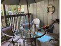 Relaxing outdoor balcony space with comfortable seating, table, and decorative accessories at 118 Salt Marsh Circle # 25B, Pawleys Island, SC 29585
