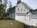 Angled view of gray two story home with garage and white trim and a front entrance portico at 1738 Cenith Dr., North Myrtle Beach, SC 29582