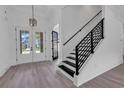 Bright and spacious entryway with double doors and a modern staircase at 2844 Mcleod Ln., Myrtle Beach, SC 29588