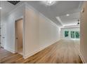 Open-concept living space with wood-look flooring, recessed lights and large windows at 205 Brush Ct., Little River, SC 29566