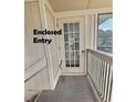 Enclosed entry with white door, carpet and railing at 4214 Pinehurst Circle # G9, Little River, SC 29566