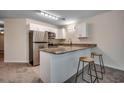 Updated kitchen with granite counters, white cabinets, and stainless-steel appliances at 1095 W Plantation Dr. W # 28D, Little River, SC 29566