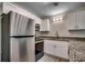 Bright kitchen featuring stainless steel appliances, granite countertops, and updated cabinets at 1095 W Plantation Dr. W # 28D, Little River, SC 29566