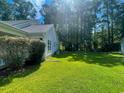 Spacious backyard featuring lush green grass and mature shade trees at 412 Callie Dr., Myrtle Beach, SC 29588