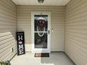 Cozy front porch entrance with a decorative wreath and a welcoming 'Home' sign at 252 Timber Run Dr., Georgetown, SC 29440