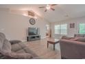 Comfortable living room with ample natural light, ceiling fan, and seamless flow into other areas at 252 Timber Run Dr., Georgetown, SC 29440