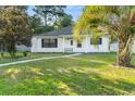 Charming white house with palm tree and walkway at 6625 Scotsman Crescent, Myrtle Beach, SC 29588