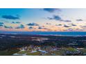 Breathtaking aerial view of the community with waterfront views and a stunning sunset at 5001 Cambria Ct., Little River, SC 29566