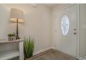 Welcoming entryway featuring decorative front door, console table with decor, and wood-look flooring at 615 Snowy Owl Way, Conway, SC 29527