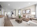 Bright living room with modern decor, plush seating, neutral color palette and wood-style flooring at 8928 Brynlee Rd. # 4B, Longs, SC 29568