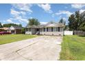 Traditional brick house with well maintained lawn, black shutters, and ample parking at 9138 Wildwood Pl., Murrells Inlet, SC 29576