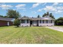 Traditional brick house with well maintained lawn, black shutters, and ample parking at 9138 Wildwood Pl., Murrells Inlet, SC 29576