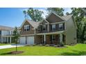 Attractive two-story home featuring a stone facade and well-manicured lawn in a suburban neighborhood at 364 Clear Lake Dr., Conway, SC 29526