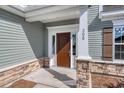 Brown front door with stone accents and white columns at 308 Happy Valley Dr., Myrtle Beach, SC 29588