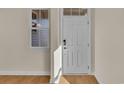 Bright entryway with white door, wood-look floors, and neutral walls at 622 Castle Ct., Myrtle Beach, SC 29579