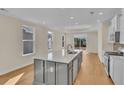 Modern kitchen with gray island, white cabinets, and stainless steel appliances at 622 Castle Ct., Myrtle Beach, SC 29579