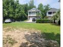 Empty lot with sandy soil and sparse grass near houses at Tbb 129 Charles Towne Ln., Murrells Inlet, SC 29576