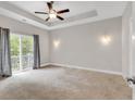 Spacious bedroom with carpeting, ceiling fan, and sliding glass doors at 202 Rivers Edge Dr., Conway, SC 29526