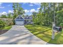 Blue house with a two-car garage and a mailbox at 202 Rivers Edge Dr., Conway, SC 29526