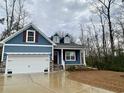 Inviting blue home featuring a two-car garage and charming curb appeal at 202 Rivers Edge Dr., Conway, SC 29526