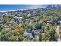 Aerial view of home nestled in a wooded area near the water at 1202 Prince William Rd., North Myrtle Beach, SC 29582