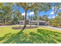 Landscaped front yard with circular driveway and mature trees at 1202 Prince William Rd., North Myrtle Beach, SC 29582