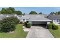 Charming single-story home featuring a well-maintained lawn, mature landscaping, and an attached garage at 213 Birkdale Ln., Myrtle Beach, SC 29588