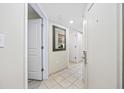 Bright hallway featuring tile flooring, white doors, and a stylish mirror, leading to a comfortable living space at 201 S Ocean Blvd. # 1005, Myrtle Beach, SC 29577