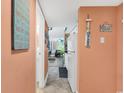 Hallway view leading into condo showcases decorated walls and colorful decor with a glimpse of the living room at 7000 Ocean Blvd. N # 133, Myrtle Beach, SC 29572
