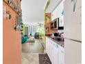 Open kitchen and living room layout featuring modern appliances and colorful, beach-themed decor, creating a vibrant space at 7000 Ocean Blvd. N # 133, Myrtle Beach, SC 29572