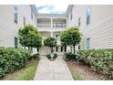 Residential courtyard with a walkway and landscaping at 500 River Oaks Dr. # 58I, Myrtle Beach, SC 29579