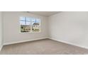 Well-lit bedroom with neutral carpet, a large window, and fresh, neutral paint at 368 Clear Lake Dr., Conway, SC 29526