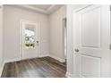 Bright entryway with wood-look flooring and a glass-paneled front door that lets in natural light at 368 Clear Lake Dr., Conway, SC 29526