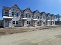 New construction townhomes featuring classic architectural details and modern design, ready for personalization at 6876 Watertower Rd. # 201, Longs, SC 29568