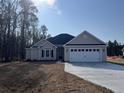 Charming single-story home with a two-car garage and a well-manicured front yard at 1033 Sioux Swamp Dr., Conway, SC 29527