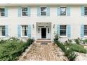 Front entry of a brick house with light blue shutters and a brick walkway at 201 River Rd., Georgetown, SC 29440