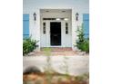 White front door and storm door with a brick walkway and landscaping at 201 River Rd., Georgetown, SC 29440