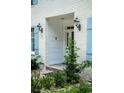 White front door with sidelights, framed by brick and light blue shutters at 201 River Rd., Georgetown, SC 29440