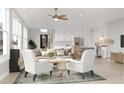 Bright living room with hardwood floors, neutral decor, ceiling fan, kitchen island, and modern recessed lighting at 2247 Sand Dunes Dr., Myrtle Beach, SC 29577