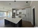 Modern kitchen featuring white cabinets, large island, and quartz countertops at 2260 Pearl Rd., Galivants Ferry, SC 29544