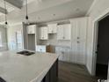 Spacious kitchen with white cabinets, large island, and quartz countertops at 2264 Pearl Rd., Galivants Ferry, SC 29544