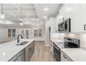 Modern kitchen featuring stainless steel appliances, white cabinets, island, and an open floorplan at 2264 Pearl Rd., Galivants Ferry, SC 29544