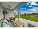 Relaxing covered patio furnished with seating and a coffee table at 313 Mayflower Dr., Calabash, NC 28467