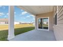 Covered patio offers an outdoor space for entertaining and relaxing with a view of the grassy backyard at 314 Cheerful Way, Little River, SC 29566