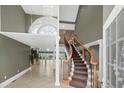Stunning foyer with high ceilings, a grand staircase, chandelier, and views of the ocean at 8000 Beach Dr., Myrtle Beach, SC 29572